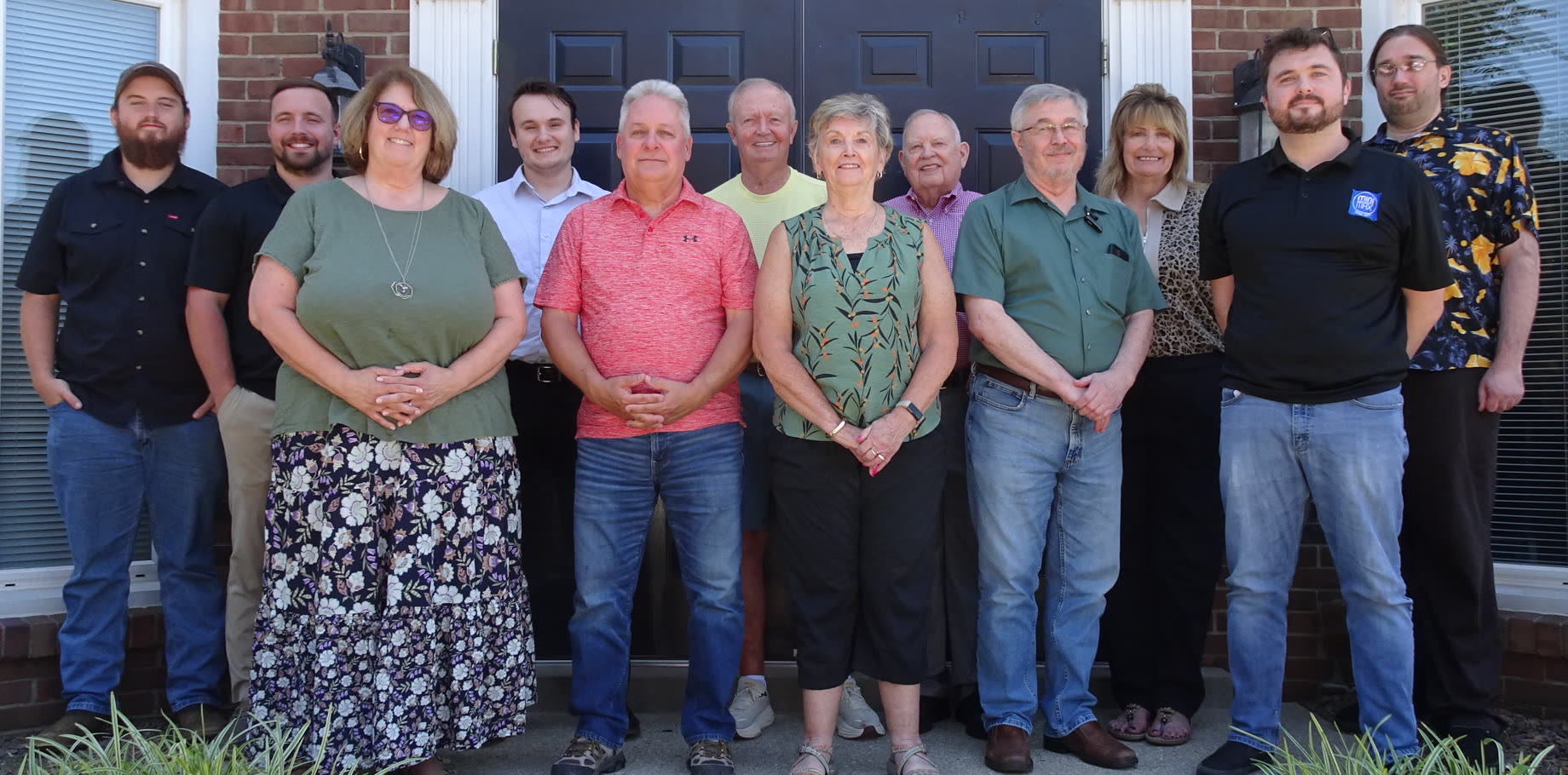 The mini-MAX Information Systems team standing together outside their office